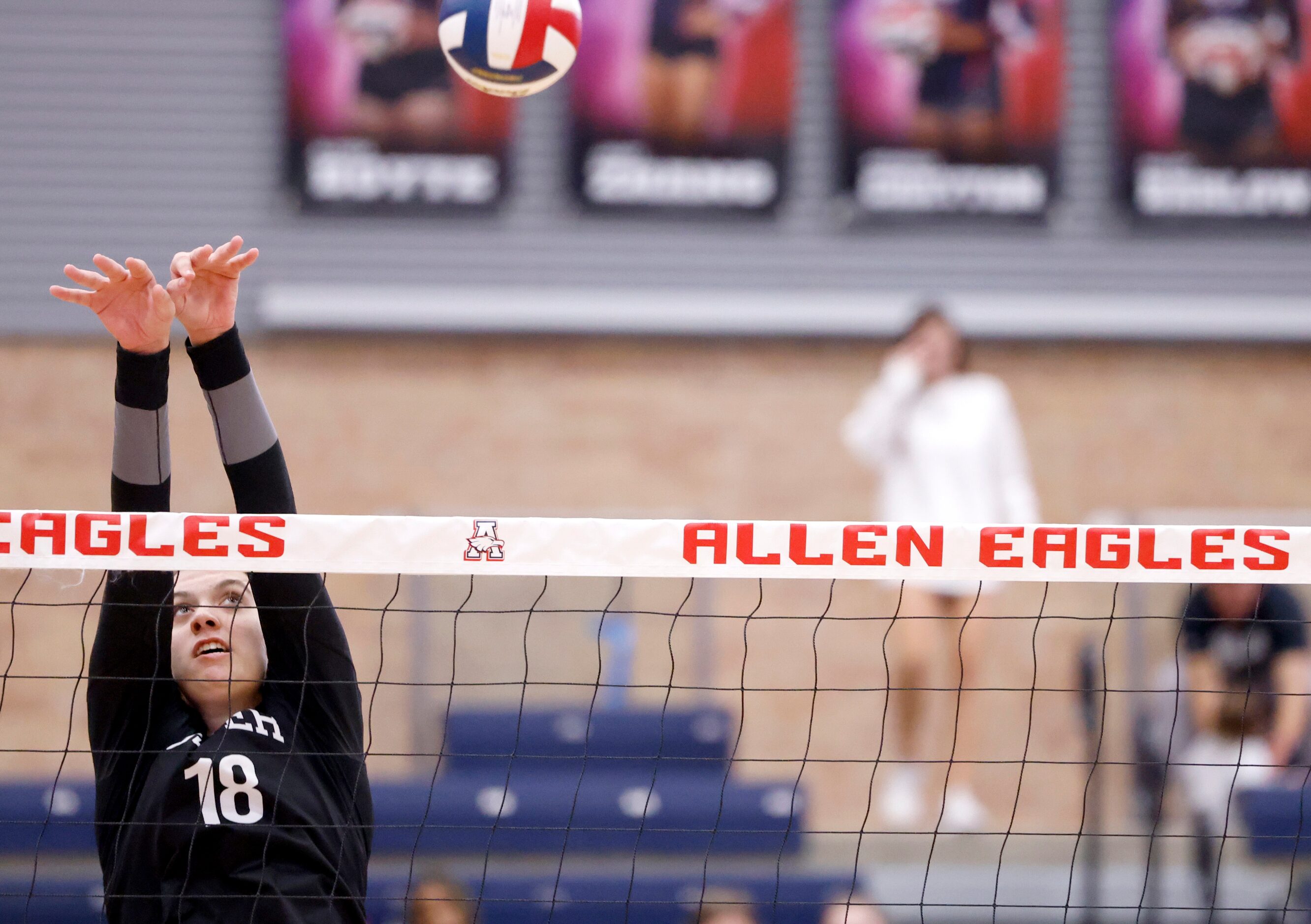 Denton Guyer senior Erika Gustafson (18) reaches over the net for a block against Allen in...