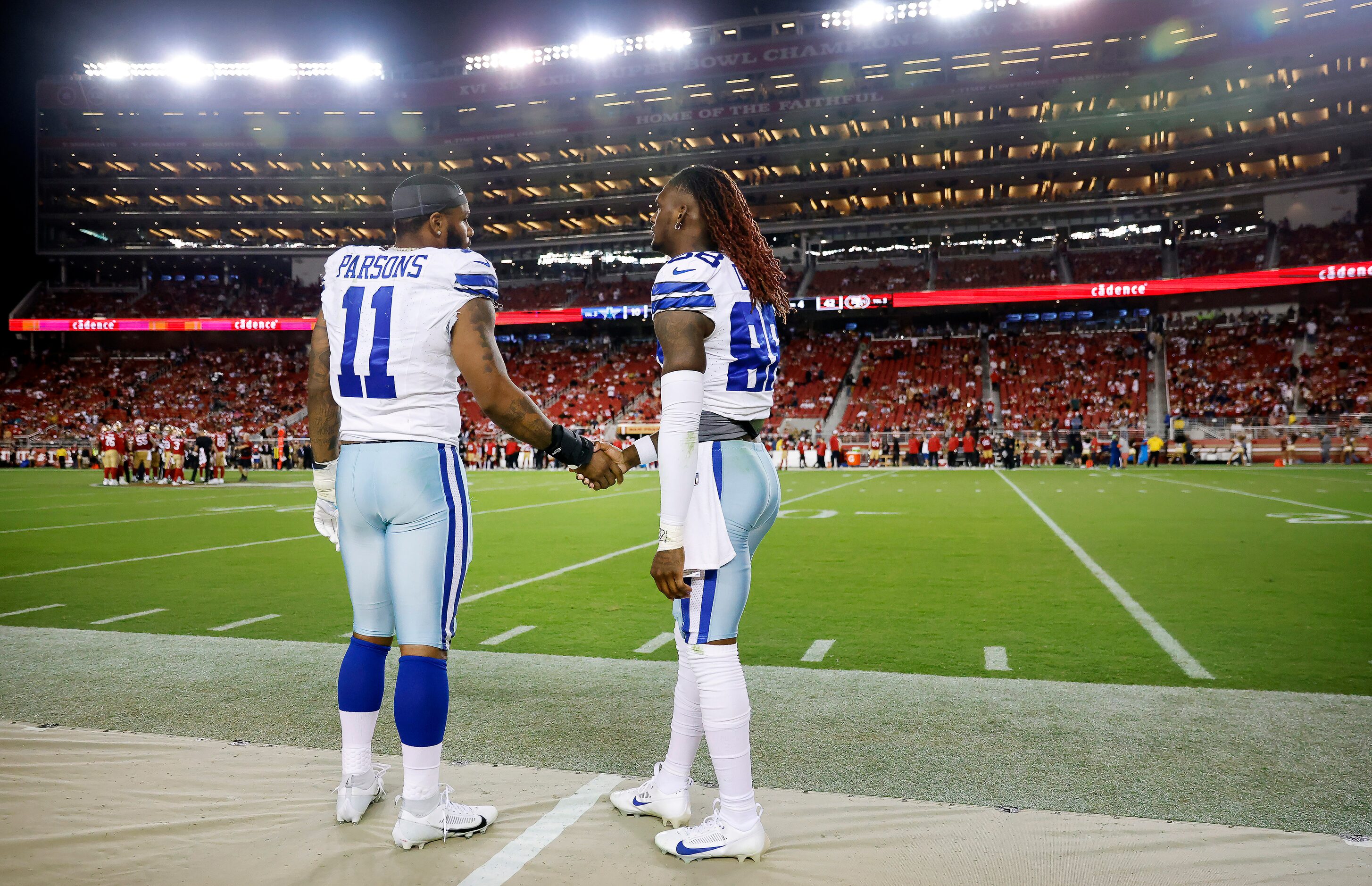 Dallas Cowboys linebacker Micah Parsons (11) shakes hands with teammate CeeDee Lamb (88) as...