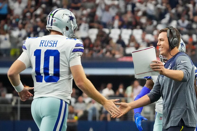 Dallas Cowboys quarterback Cooper Rush (10) gets a hand from offensive coordinator Kellen...
