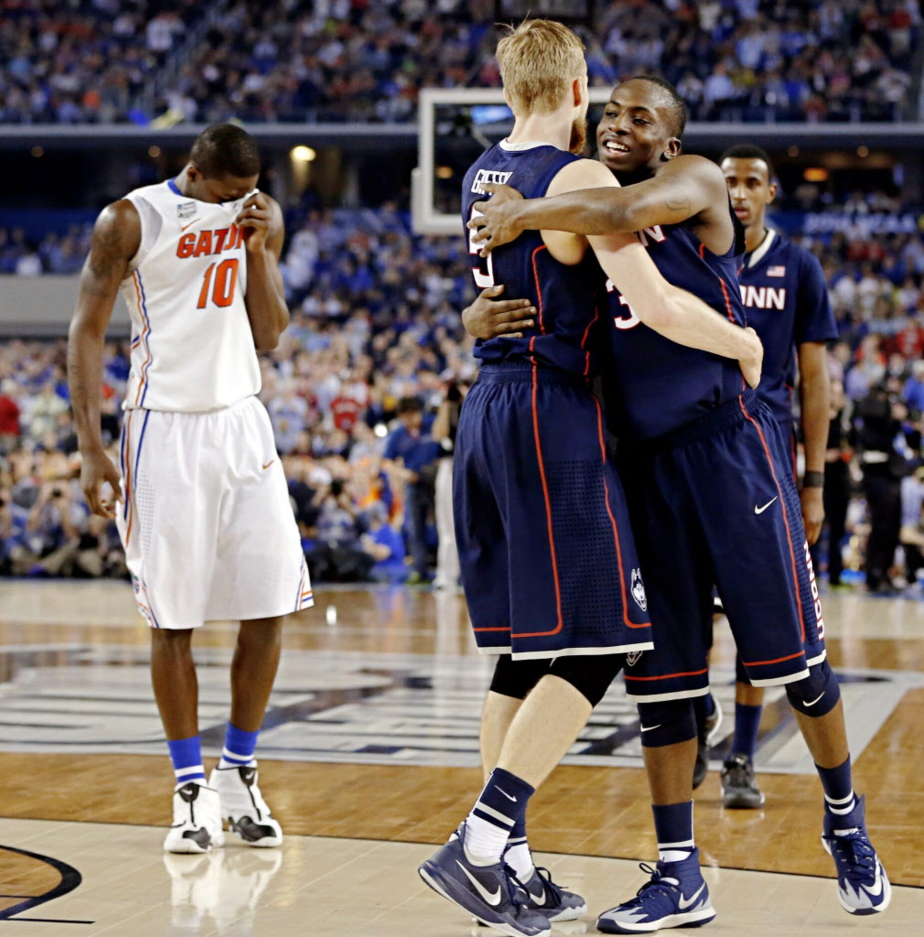 Connecticut Huskies guard/forward Niels Giffey (5) and guard Terrence Samuel (3) hug while...