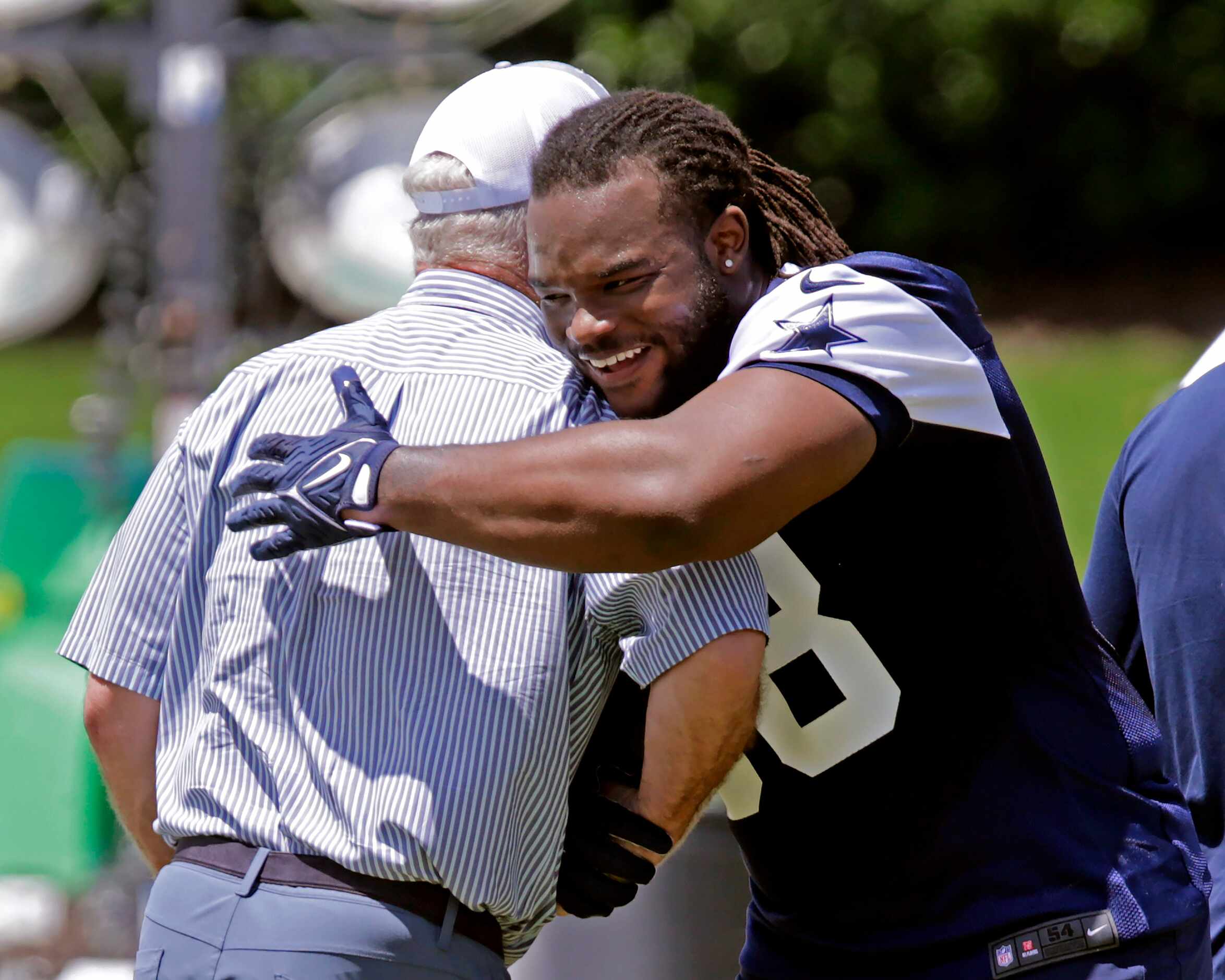Cowboys first round pick, defensive tackle Mazi Smith (58) embraces Cowboys Executive Vice...
