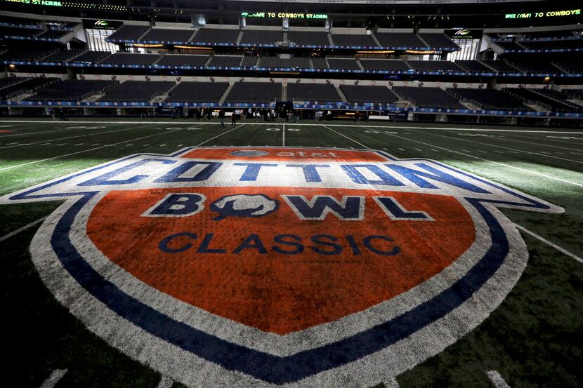 Sun shines on the midfield logo for the Cotton Bowl at Cowboys Stadium on Sunday, Dec. 30,...