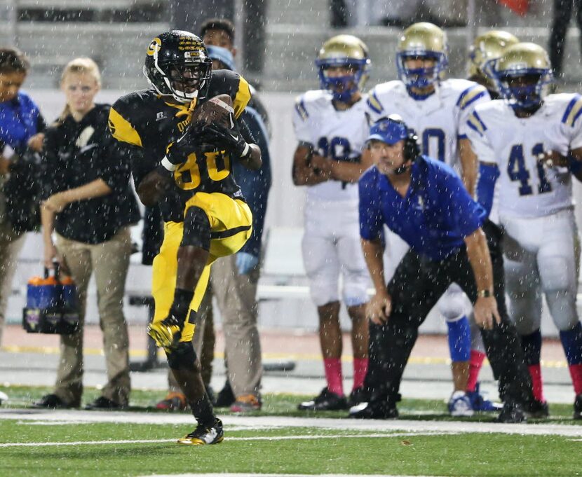 Garland's Michael Lee (88) catches a pass in the pouring rain during a game against Garland...