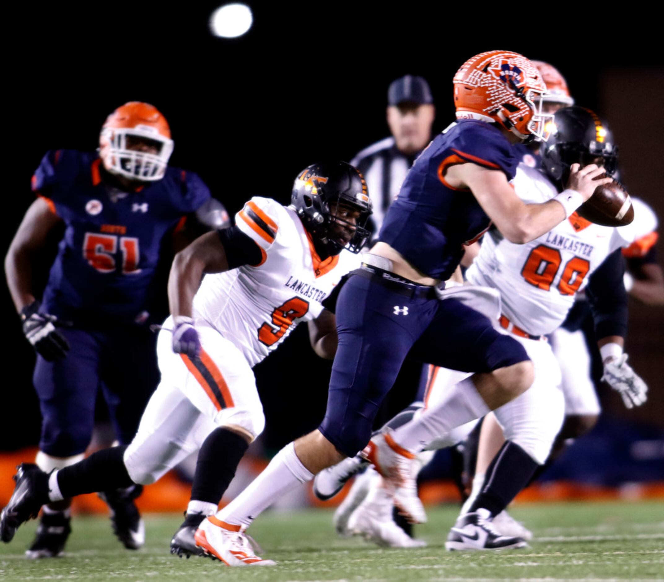 McKinney North quarterback Dillon Markiewicz (4) rolls out of the pocket to avoid pressure...