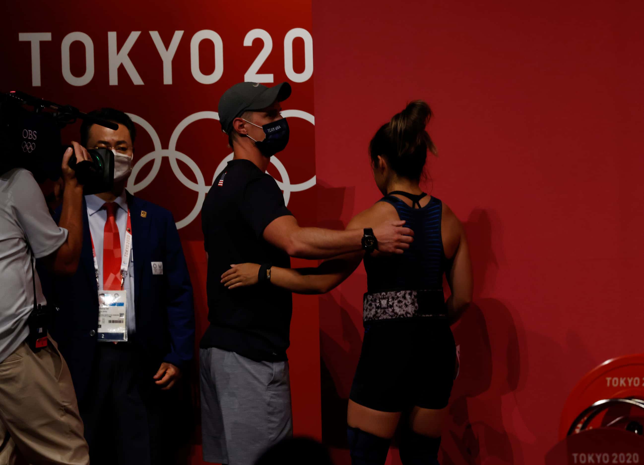 USA’s Jourdan Delacruz is consoled by her coach Spencer Arnold after an unsuccessful attempt...