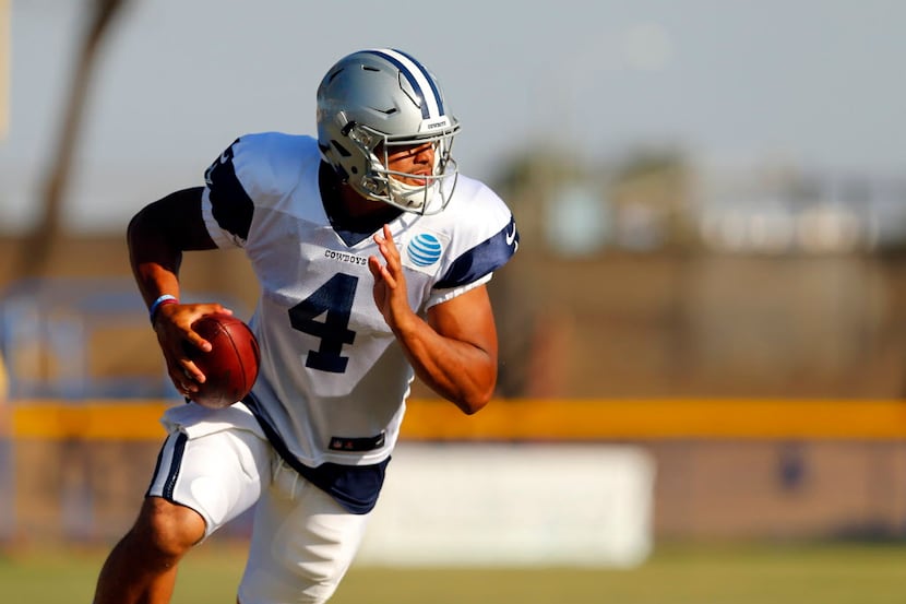 Dallas Cowboys quarterback Dak Prescott (4) rolls out looking for a receiver during...