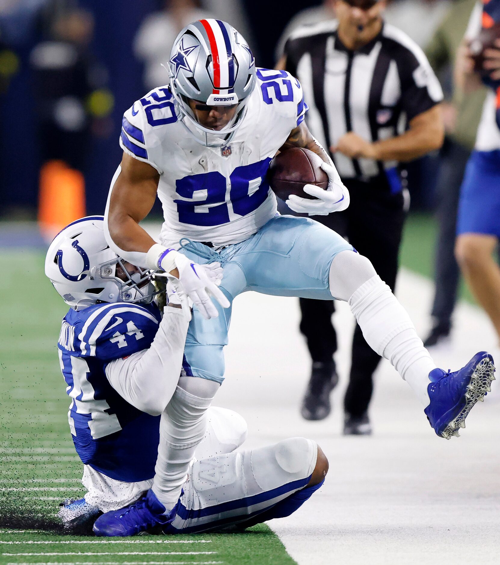 Dallas Cowboys running back Tony Pollard (20) is dragged out of bounds by Indianapolis Colts...