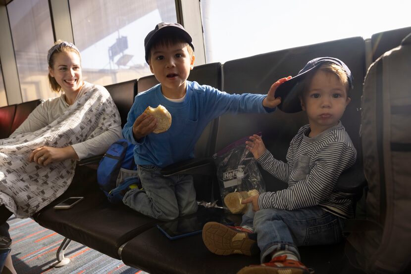 Katherine Chou of Philadelphia looks over at sons Everett, 4, and Spencer, 2, while...