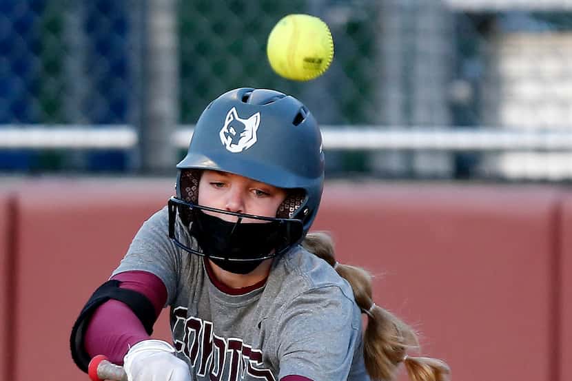 Heritage pitcher Jensin Hall (51) pops out on a bunt attempt in the second inning as...