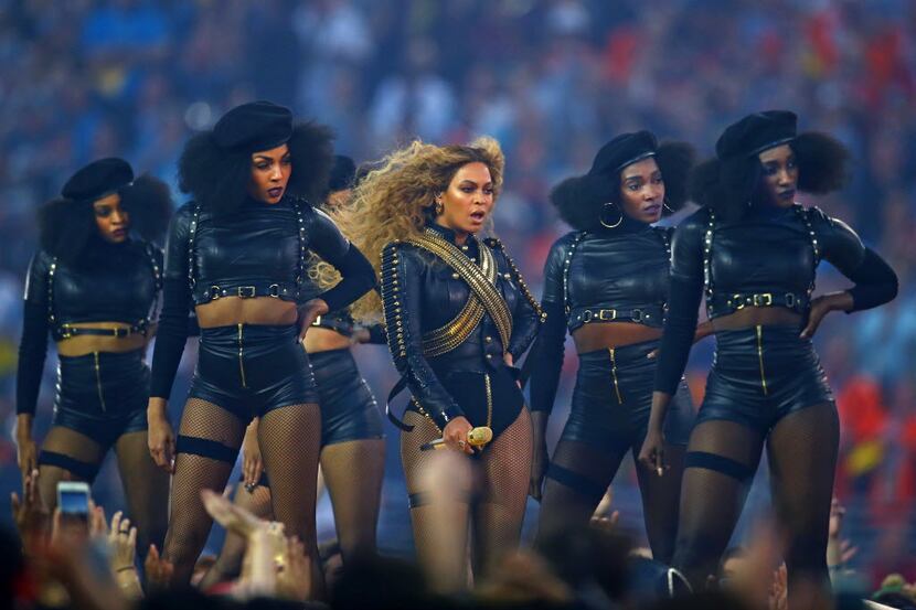 Beyonce performs at halftime with dancers in Super Bowl 50 between the Carolina Panthers and...
