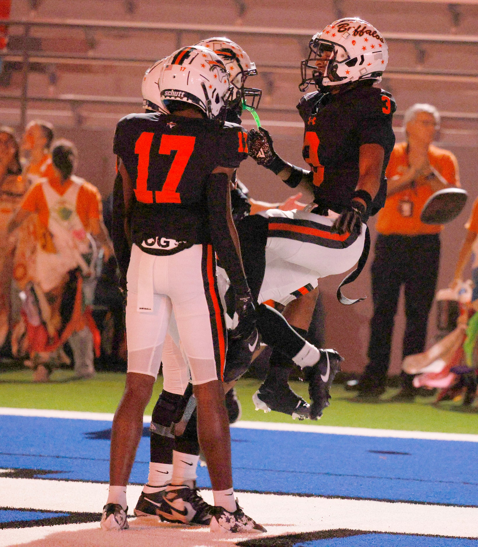 Haltom's Keenan Jackson (3) celebrates with his teammates Semaj Lee (17) and Abdalslam...