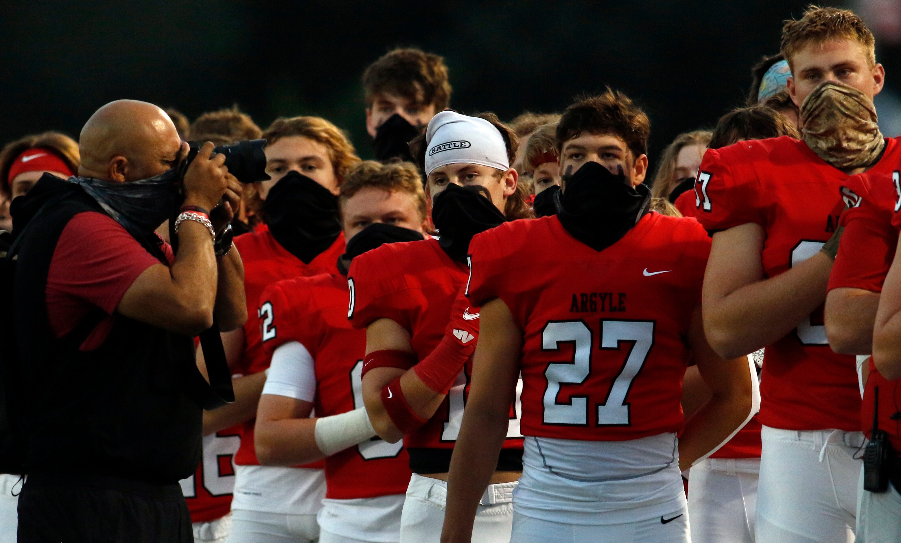 Members of the Argyle Eagles pause for the playing of the national anthem prior to the...