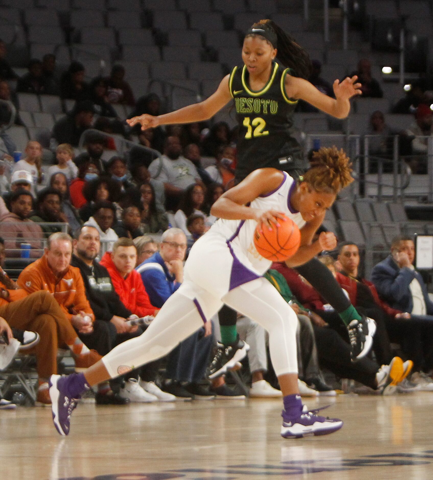 DeSoto senior Jiya Perry (12) towers defensively over Montverde Academy forward Janiah...