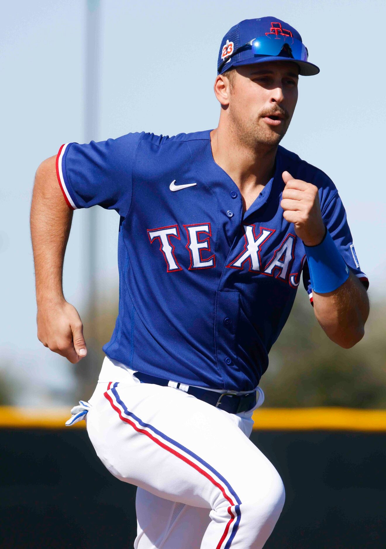 Texas Rangers first baseman Nathaniel Lowe takes part in a drill during a spring training...