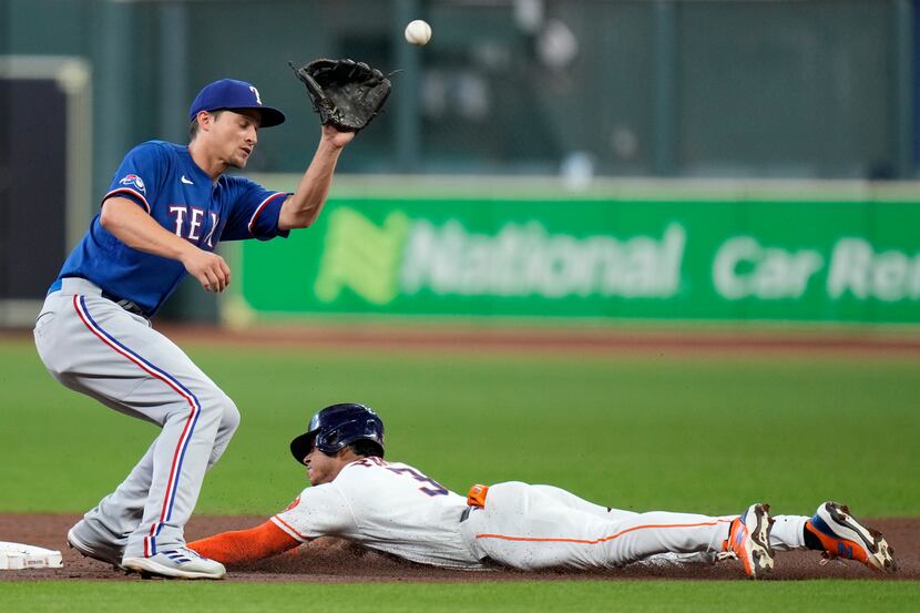 Houston Astros' Jeremy Pena steals second as Texas Rangers shortstop Corey Seager waits for...