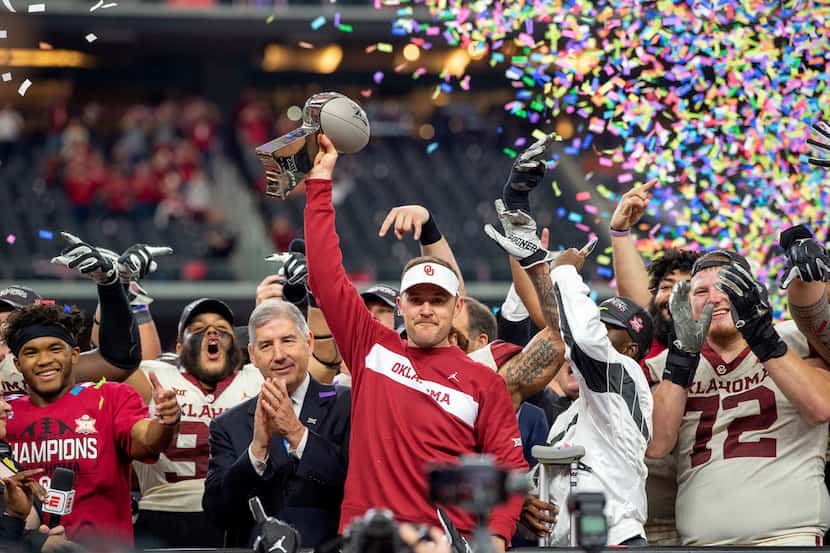 FILE - In this Dec. 1, 2018, file photo, Oklahoma head coach Lincoln Riley hoists the Big 12...