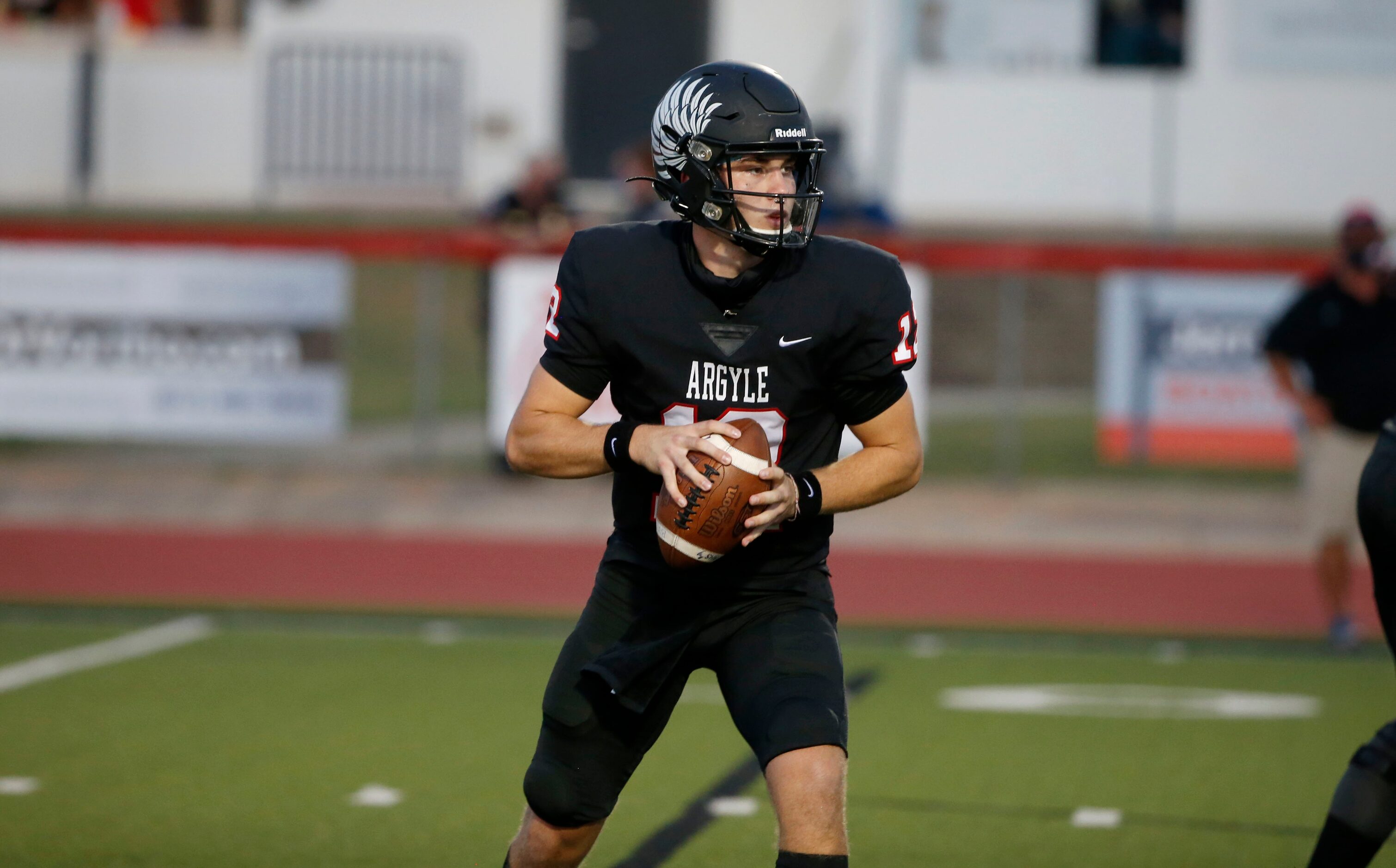 Argyle quarterback CJ Rogers (12) prepares to throw during a high school football game...