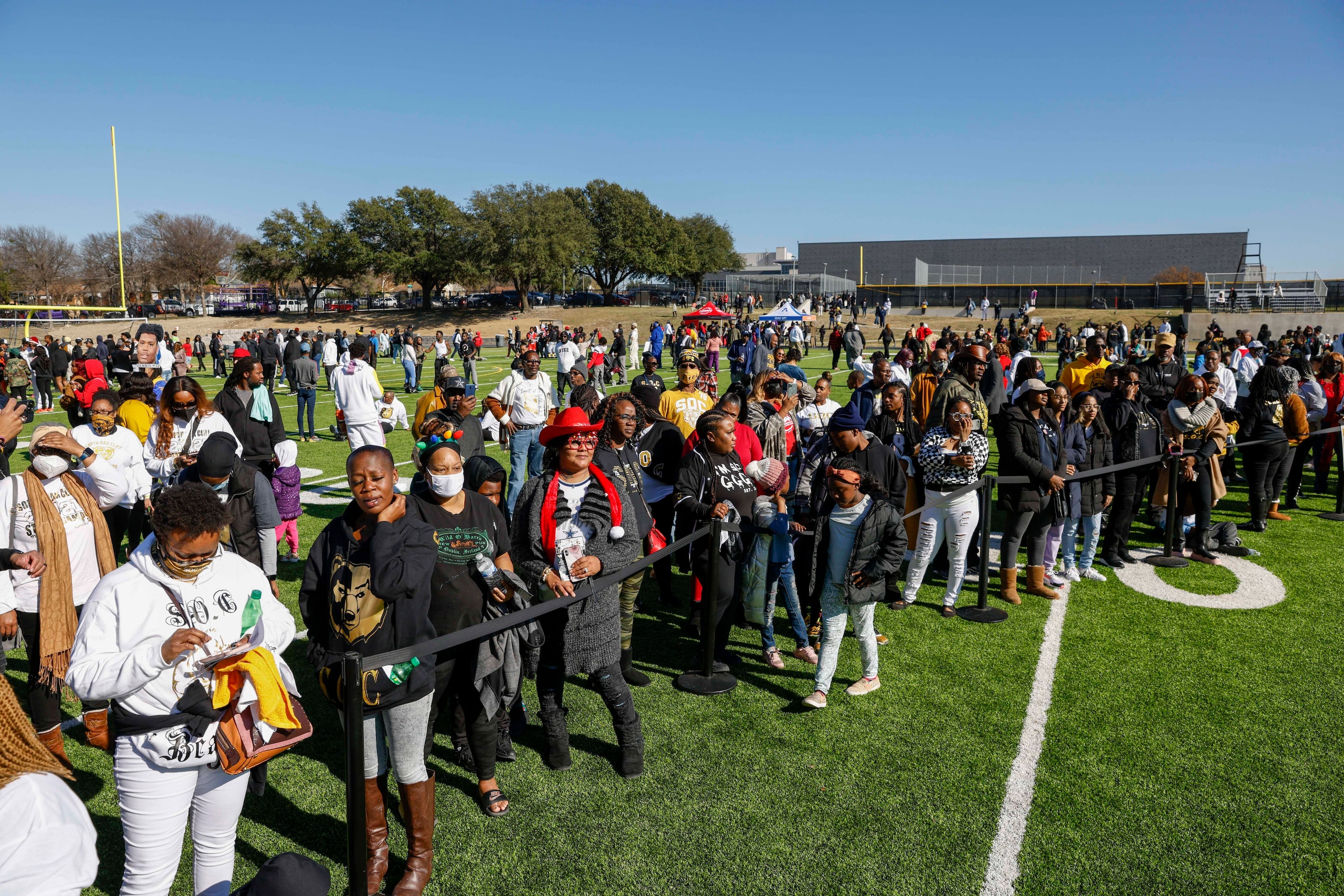 Community members and fans stand on the field during a celebration for South Oak Cliff’s...