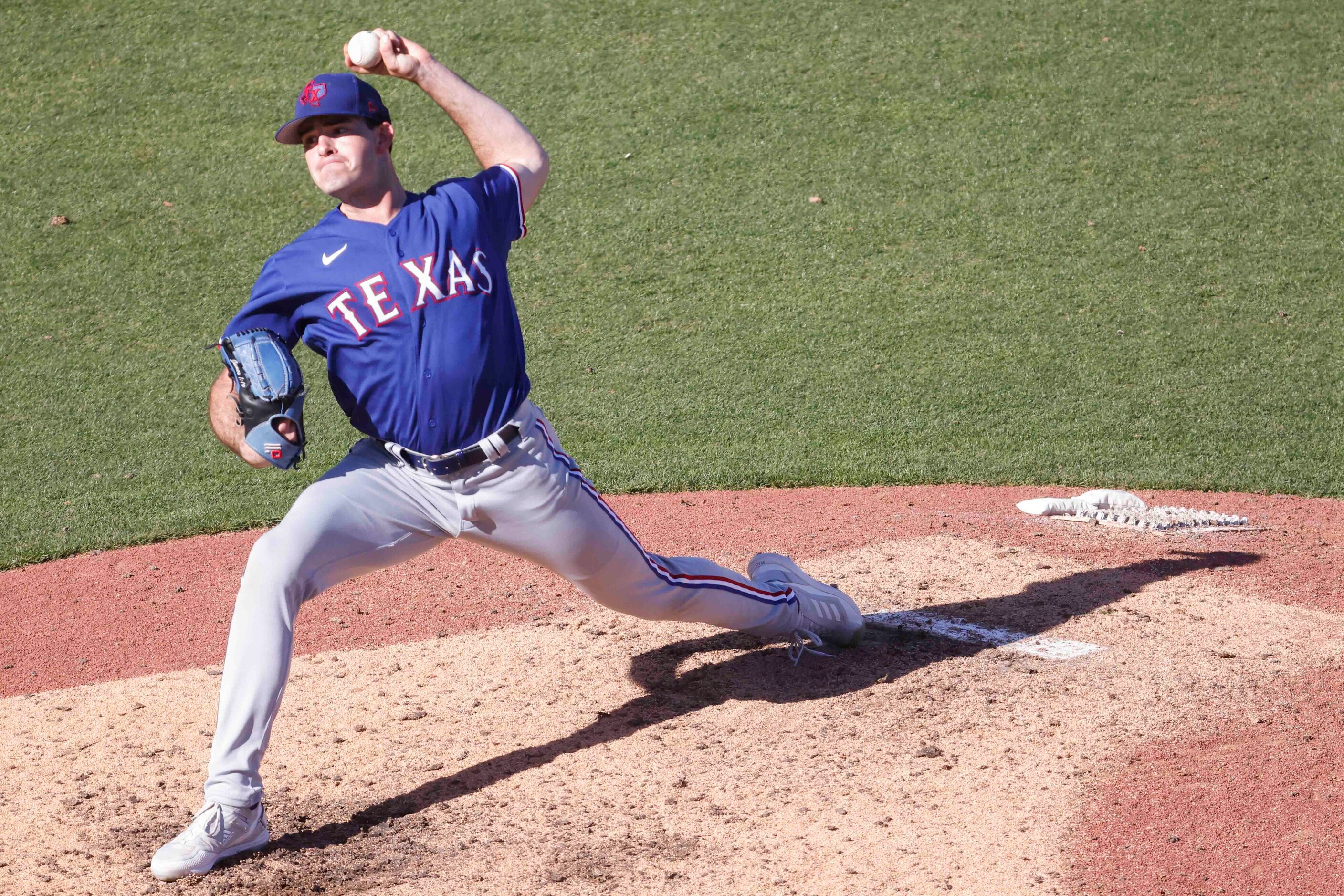 Texas Rangers Cody Bradford throws a pitch during the eighth inning of a spring training...