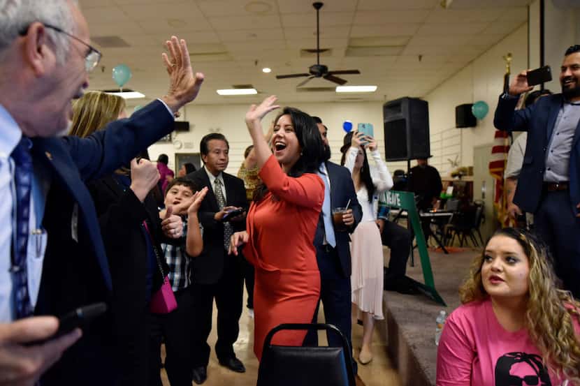 Democratic State House District 107 challenger Victoria Neave, center, celebrates with high...