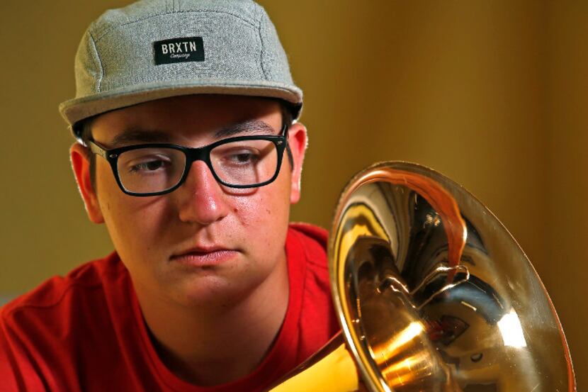 Beau Ballard, 17, a senior at Aledo High School, poses for a photograph with his  trombone...