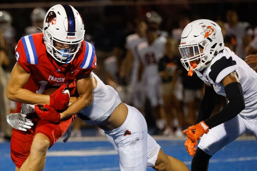 Parish Episcopal School’s Hutch Crow (12), left, gets tackled by Aledo High’s Jake...