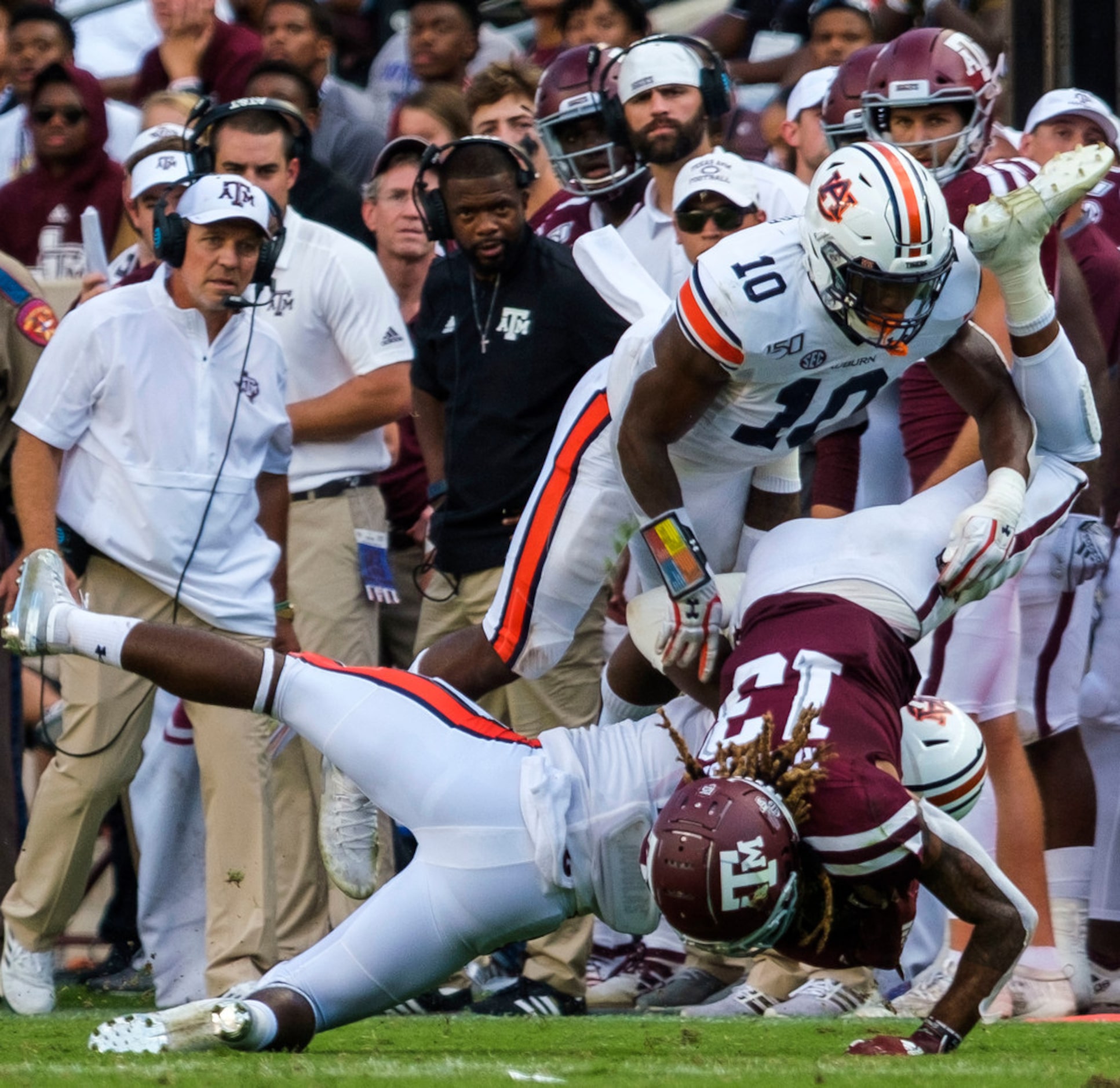 Texas A&M wide receiver Kendrick Rogers (13) is upended by Auburn defensive back Daniel...