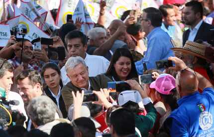 Mexican President Andres Manuel Lopez Obrador shakes hands with supporters during a unity...