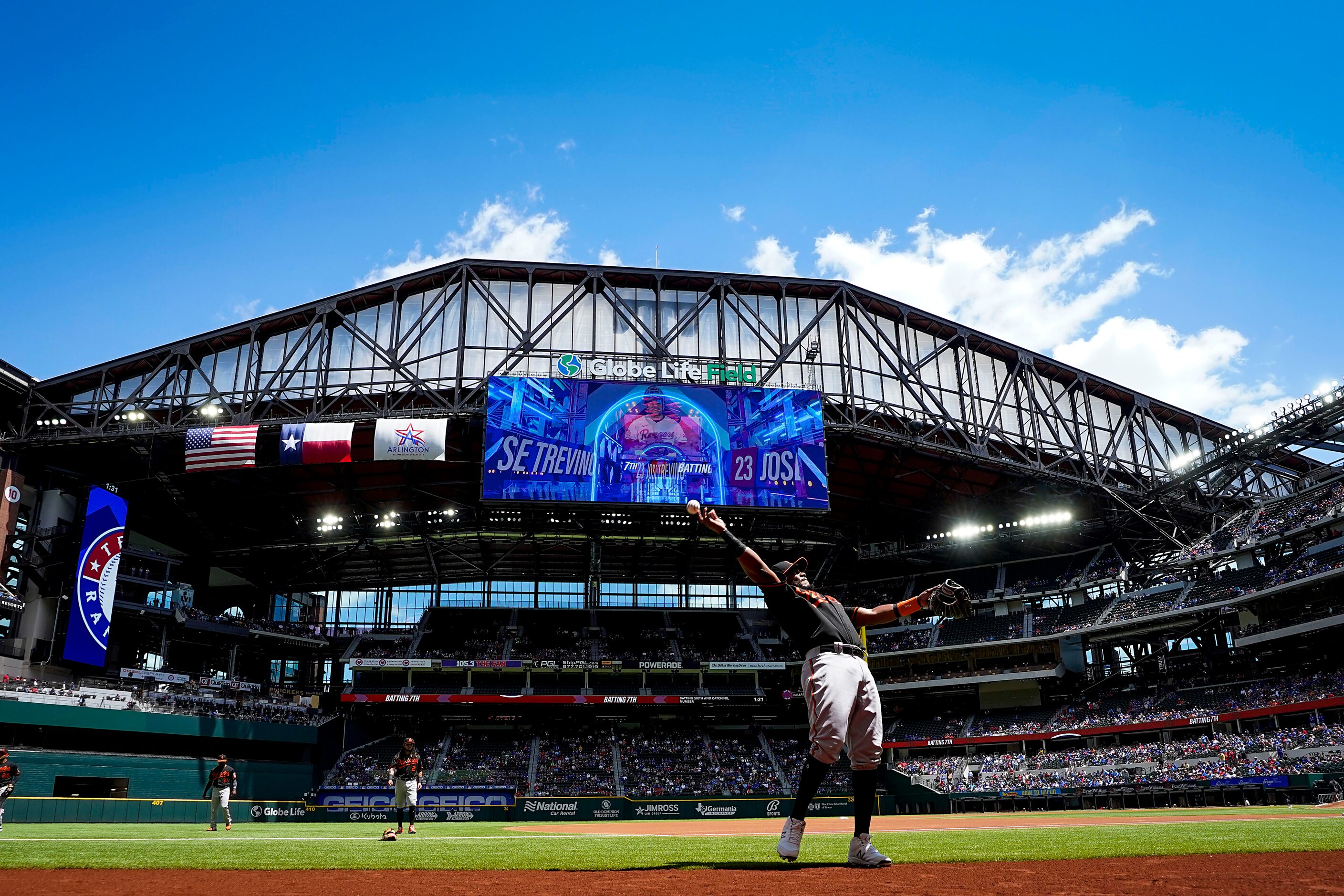 Baltimore Orioles third baseman Maikel Franco tosses a ball to the crowd before a game...