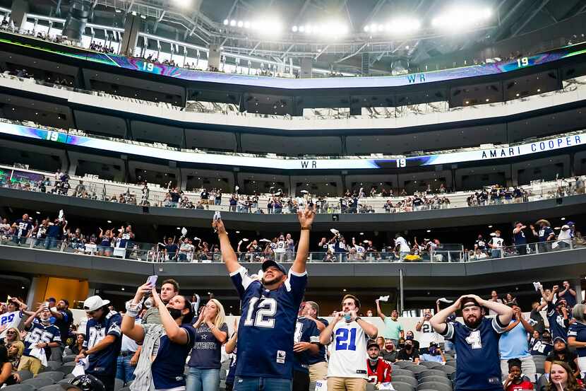 Dallas Cowboys fans celebrate after a long reception by wide receiver Amari Cooper during...