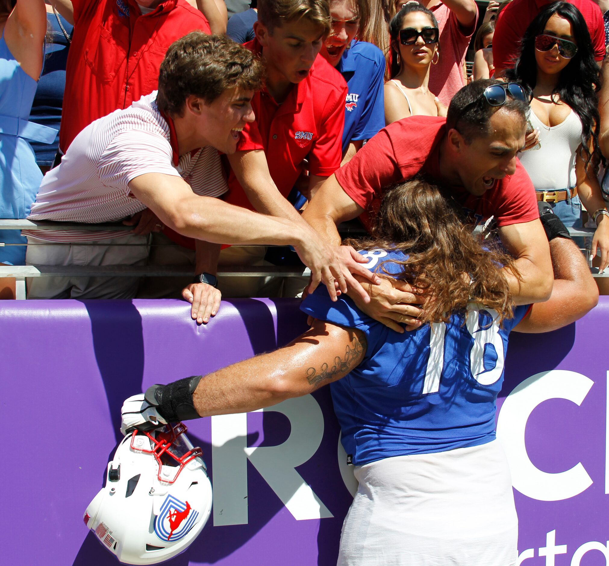 SMU offensive lineman Beau Morris (78) receives a big hugs from fans following the Mustangs'...