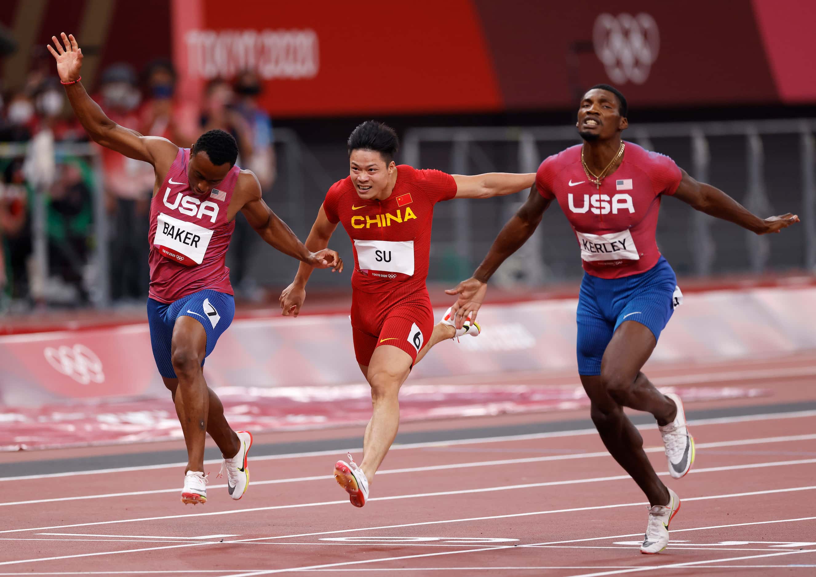 USA’s Ronnie Baker, Su Bingtian, and Fred Kerley race to the finish in the men’s 100 meter...
