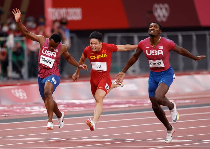 USA’s Ronnie Baker, Su Bingtian, and Fred Kerley race to the finish in the men’s 100 meter...