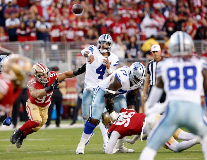 Dallas Cowboys quarterback Dak Prescott (4) throws a pass completion to wide receiver CeeDee...