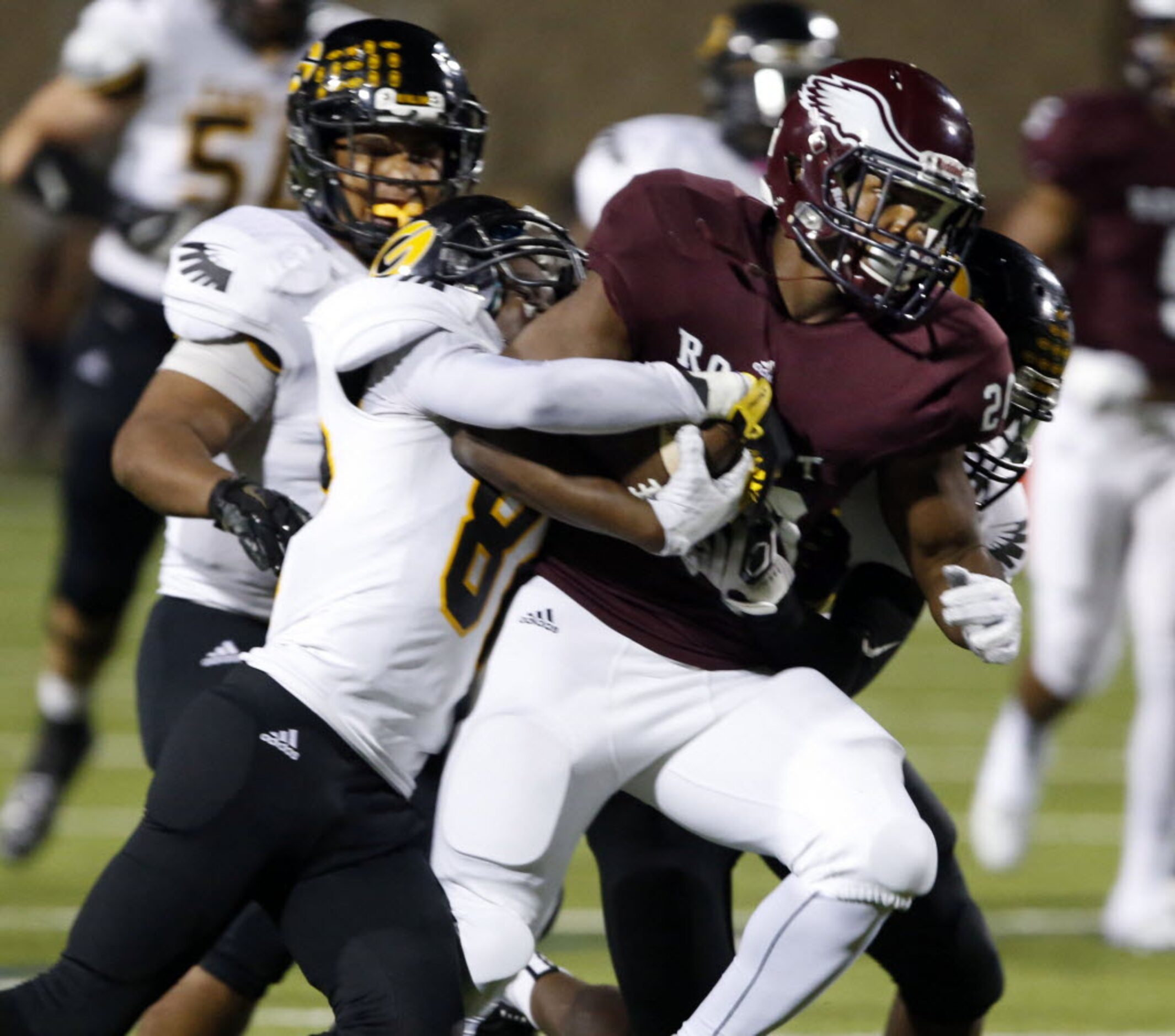 (TXHSFB) Garland defender Navaje Bradley (80) tries to strip the ball from Rowlett WR...