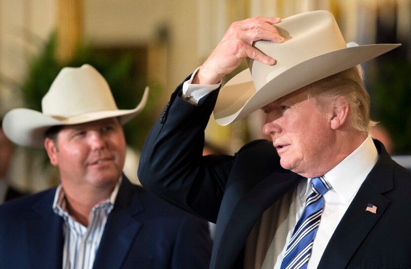 President Donald Trump puts on a Stetson hat during a Made In America product showcase event...