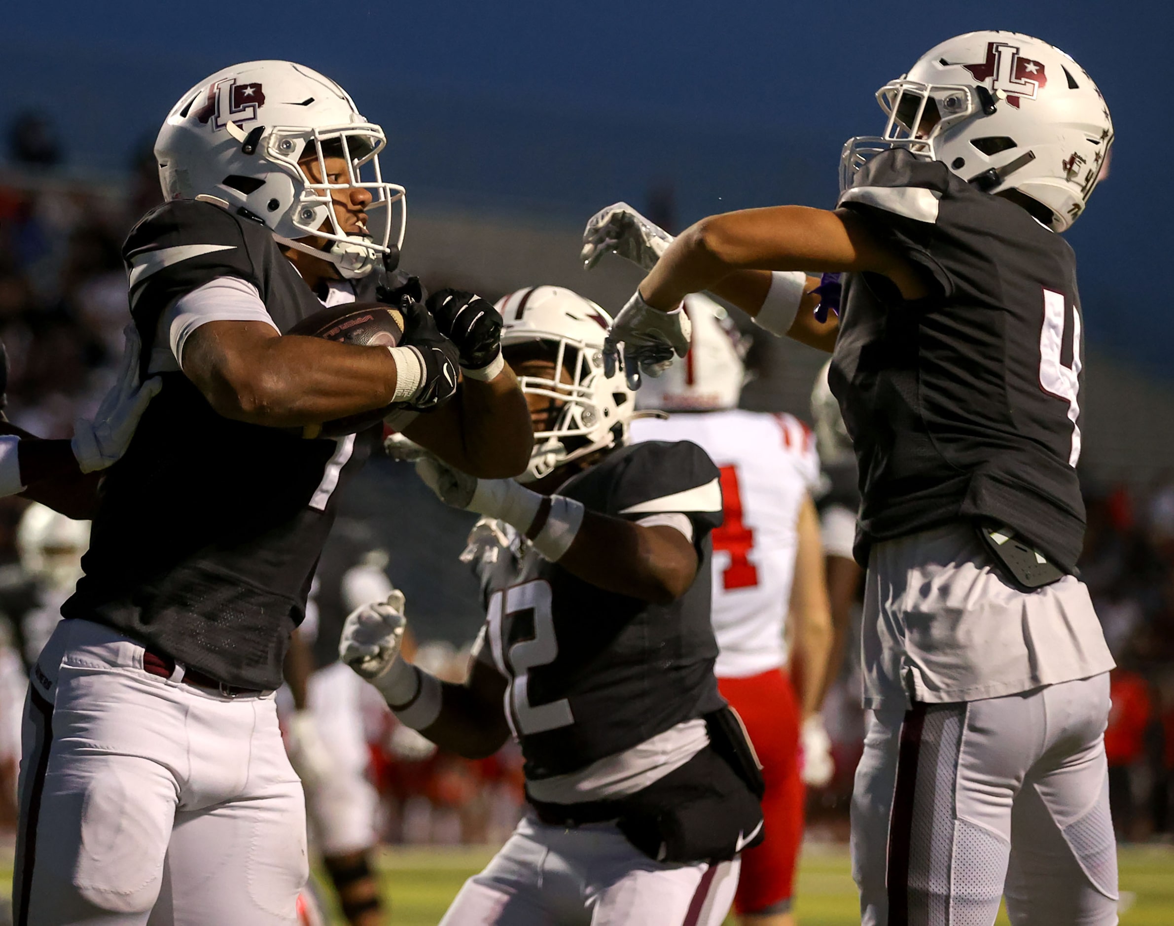 Lewisville running back Tenel Hill (L) and wide receiver Traejan Mueller (4) celebrate after...