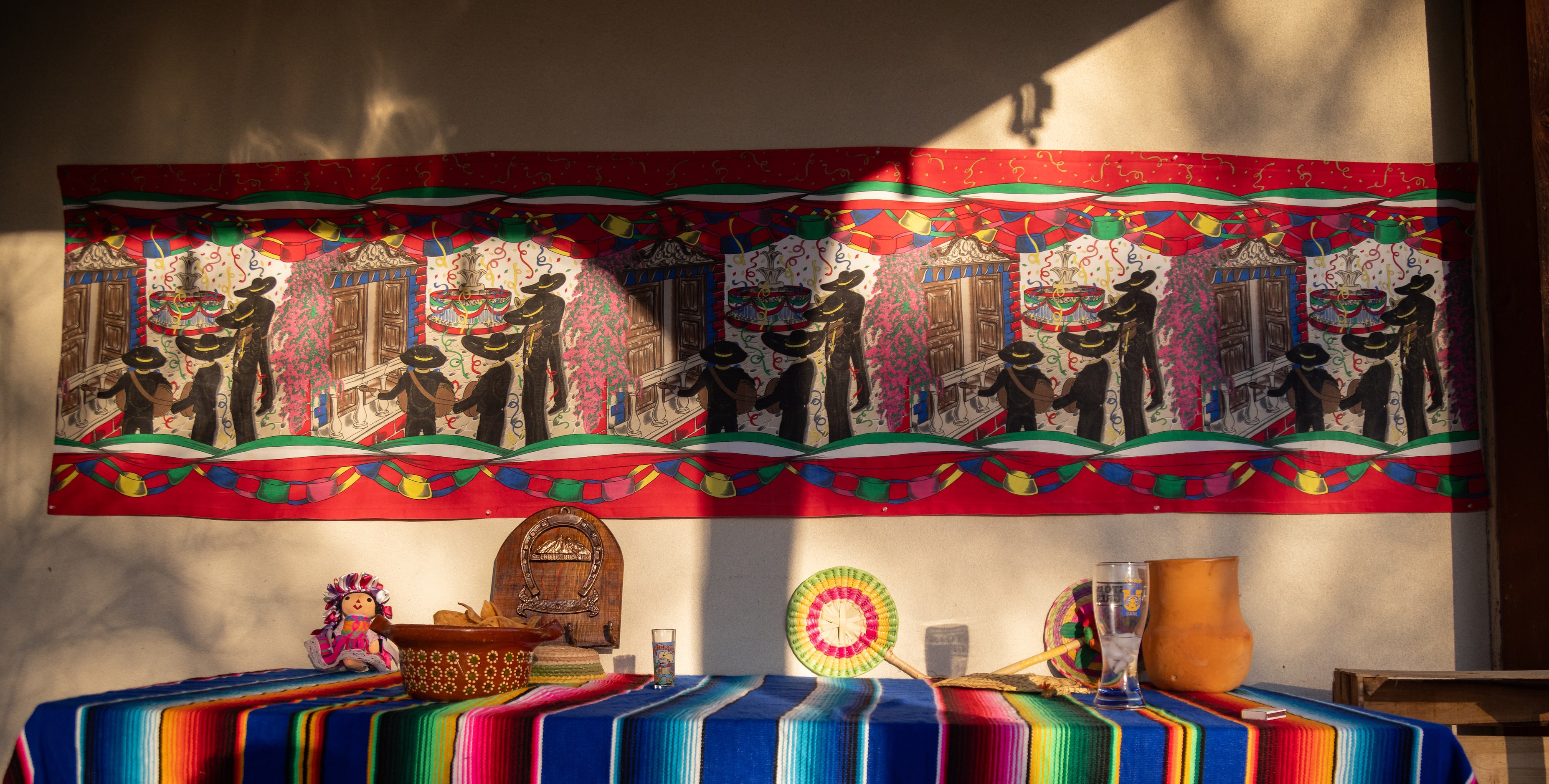 Decorations from Mexico seen as Montemayor prepares a cabrito al ataud for a carne asada.