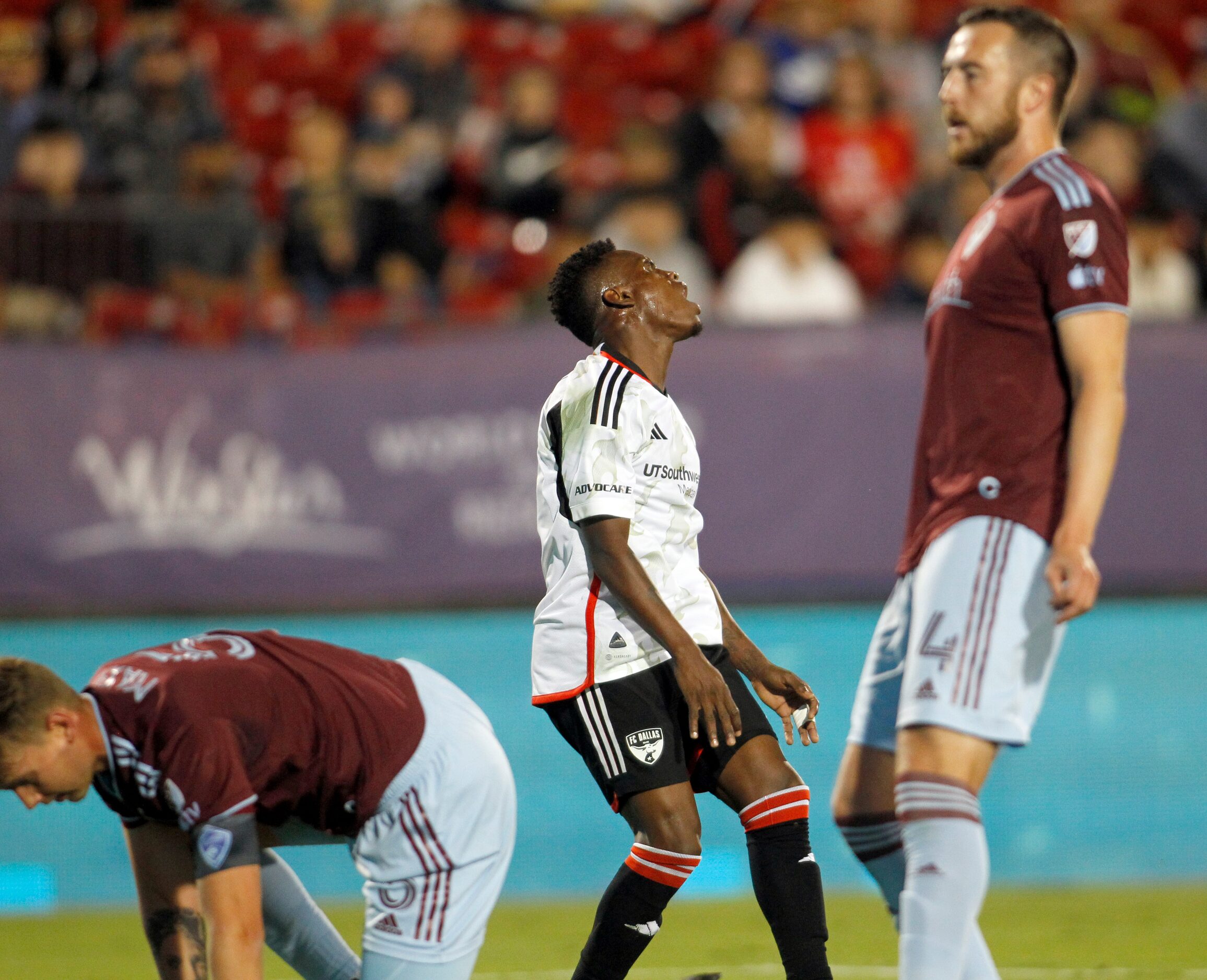 FC Dallas attacker Jader Obrian (8), center, reacts after missing a shot on goal as he is...