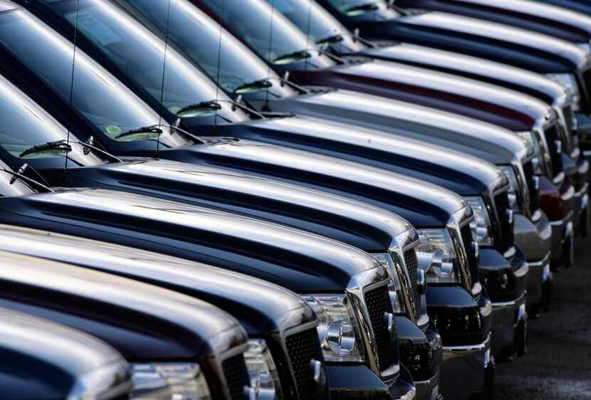 FILE - In this Sunday, Nov. 5, 2006, file photo, unsold F-150 pickup trucks sit on the lot...