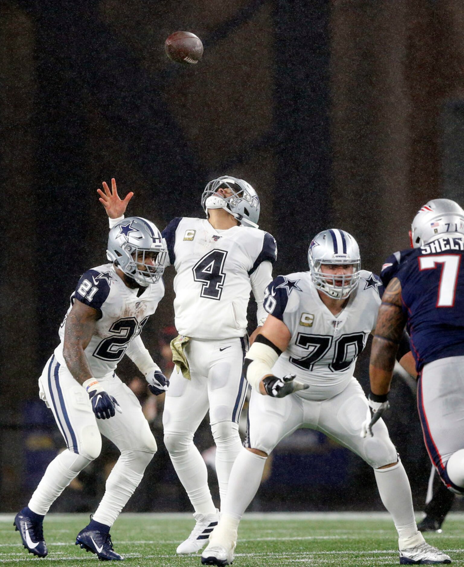 Dallas Cowboys quarterback Dak Prescott (4) looks skyward after a deep snap bounced off his...