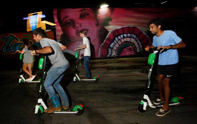 Scooter enthusiasts take off from the parking lot of a restaurant in the 2200 block of North...