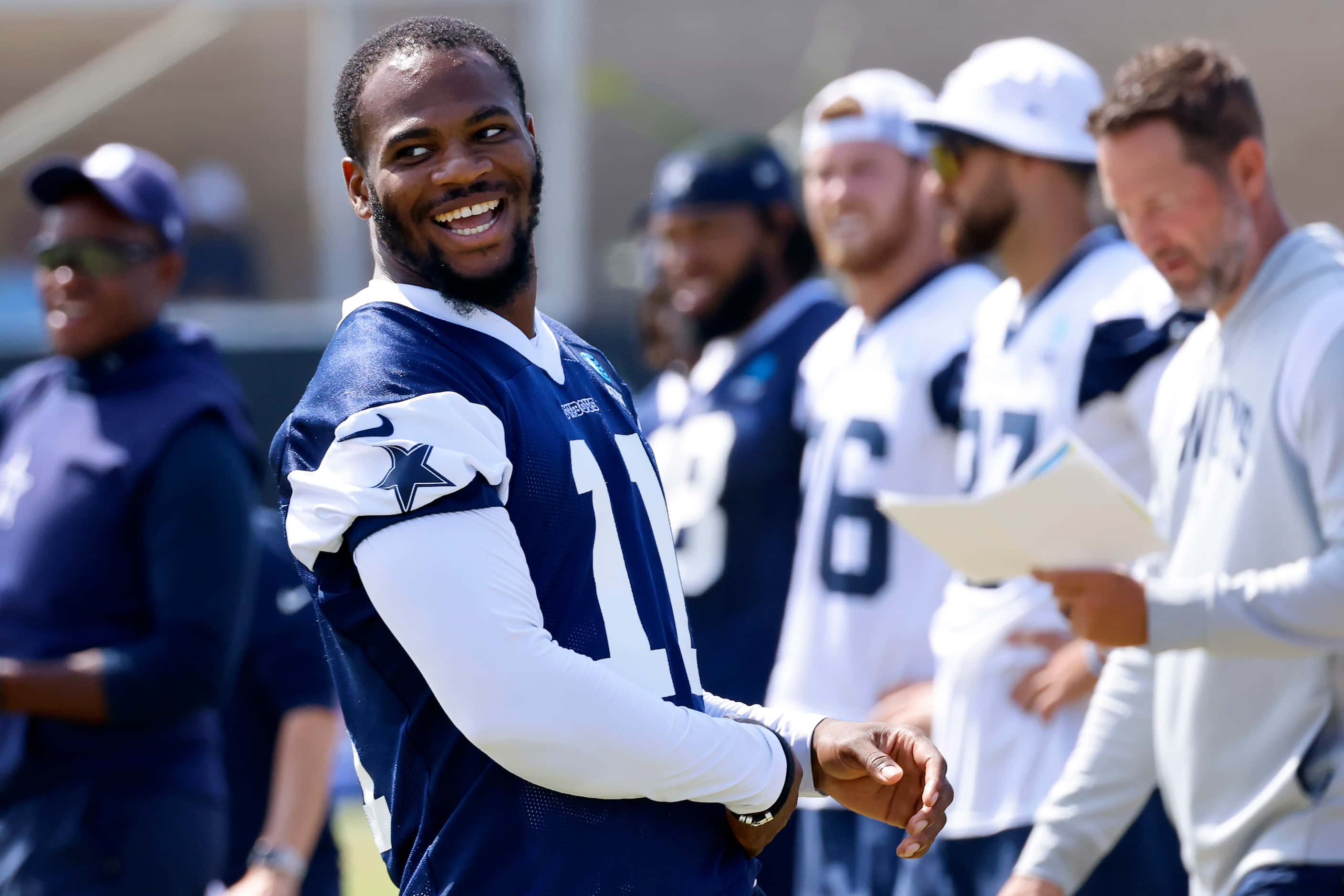 Dallas Cowboys wide receiver Jalen Tolbert (1) laughs as he got to the quarterback during a...