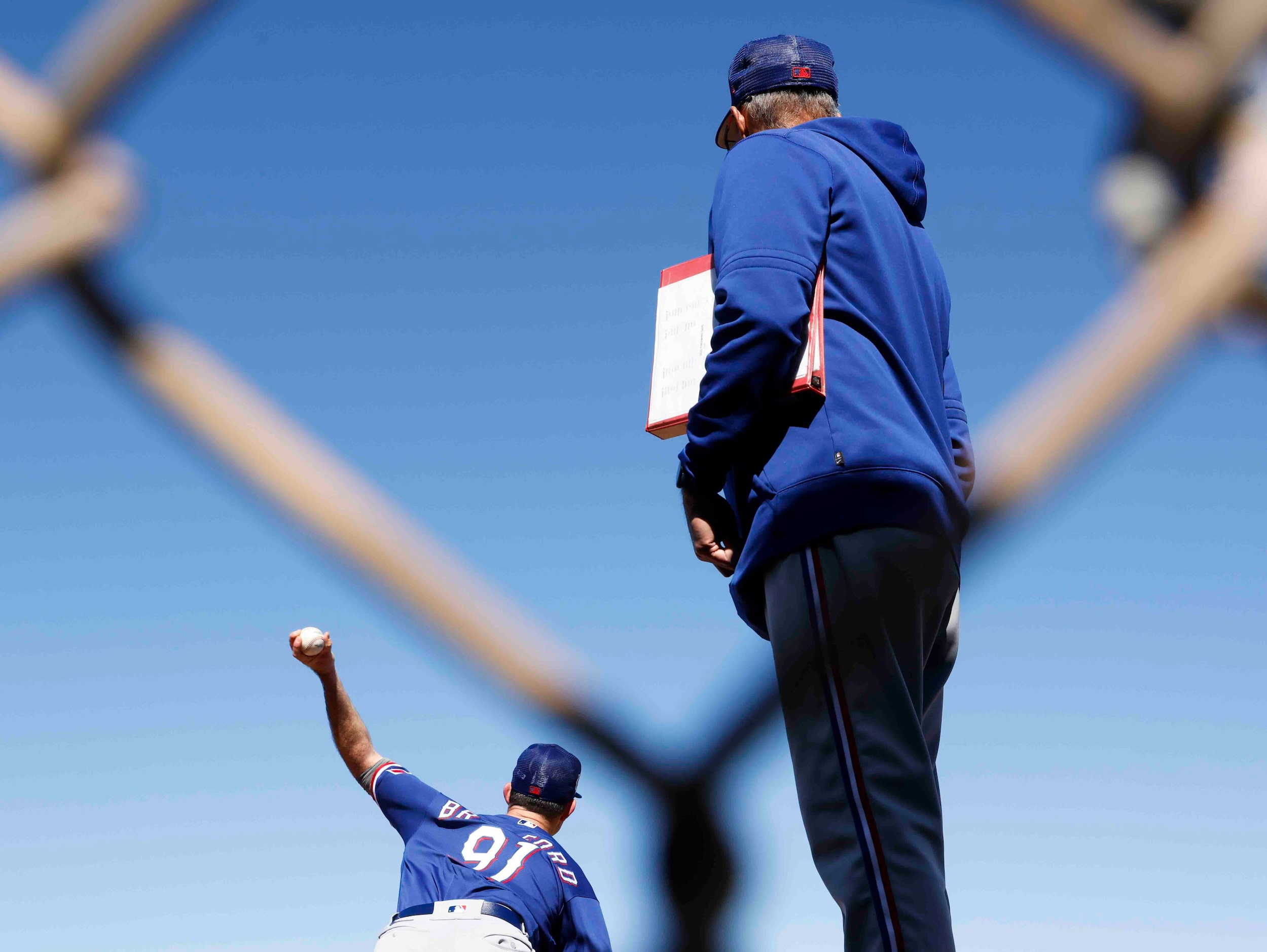 Texas Rangers pitching coach Mike Maddux, right , observes left handed pitcher Cody Bradford...