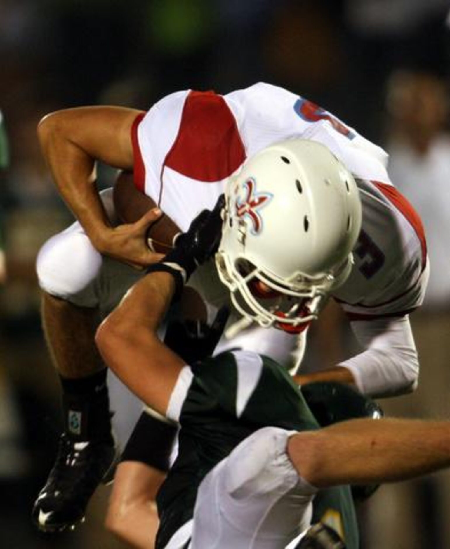 First Baptist Saints quarterback Zach Gregory (3) is sacked for a loss by Frisco Legacy...