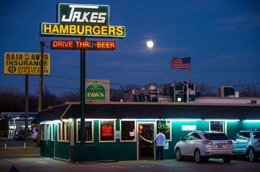 The moon rises over Jake's Uptown hamburgers  on Skillman Road at Walling Lane on Wednesday,...