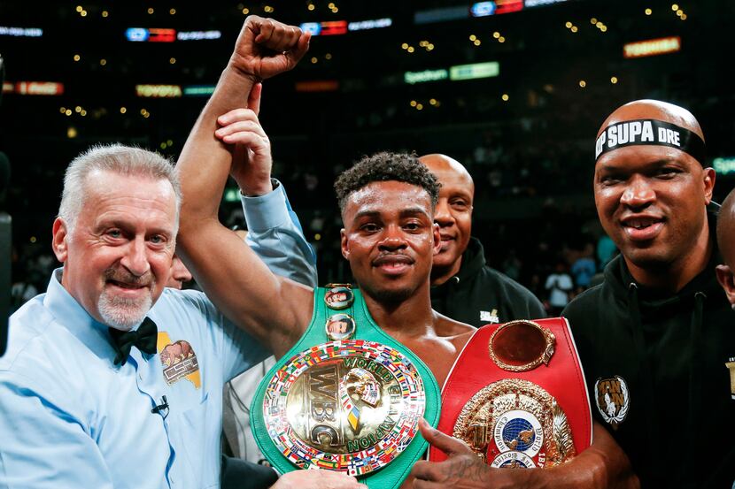 FILE - IN this Sept. 28, 2019, file photo, Errol Spence Jr., center, celebrates his victory...