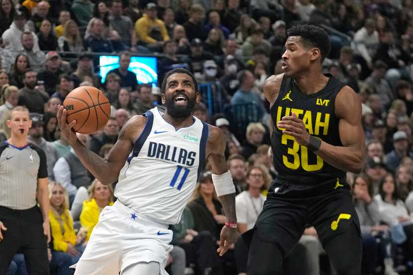 Dallas Mavericks guard Kyrie Irving (11) drives as Utah Jazz guard Ochai Agbaji defends...