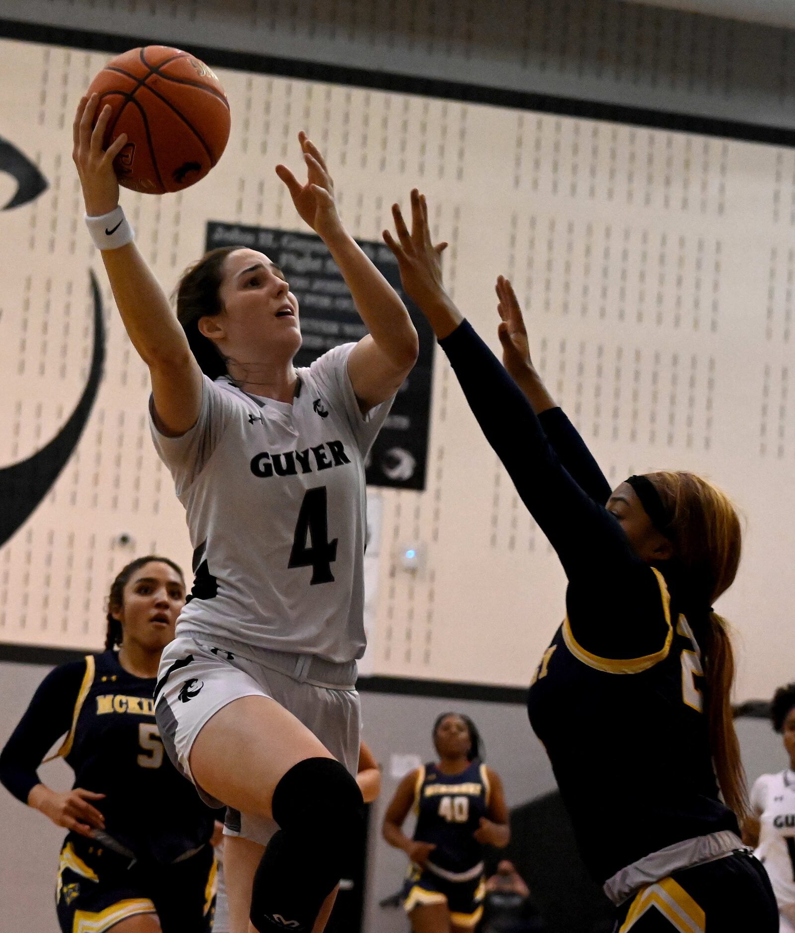 Denton Guyer’s Evie Goetz drives on McKinney’s Chioma Ukaji in the first half of a girls...