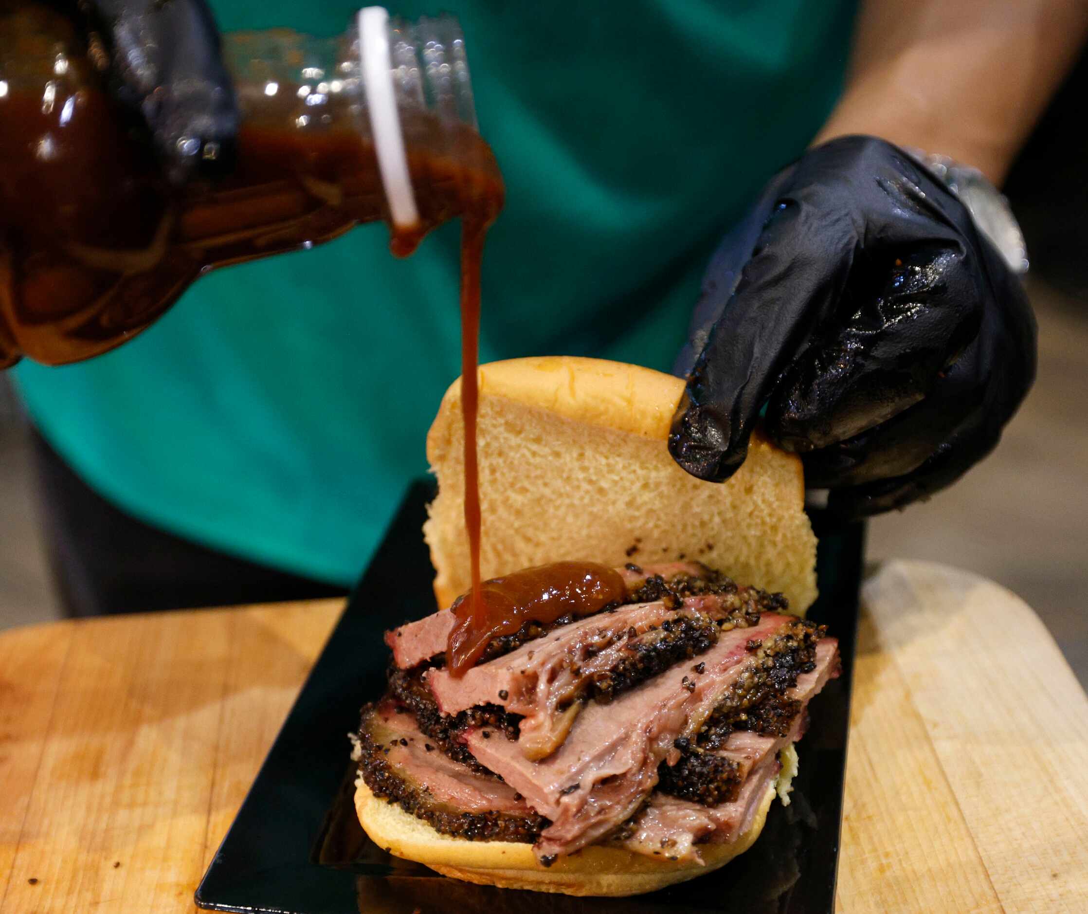 A brisket sandwich from Zavala’s Barbecue is seen during a media day at American Airlines...